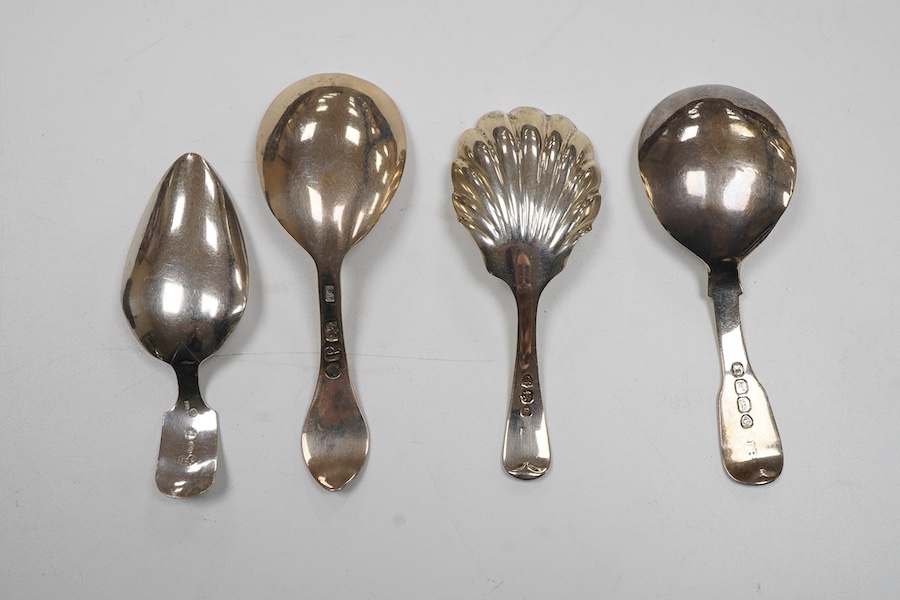 A George IV silver fiddle pattern caddy spoon, the bowl engraved with thistles, James Beebe, London, 1825, 90mm, a Georgian siler caddy spoon, the bowl embossed with urn and flowers, a late Victorian silver caddy spoon w